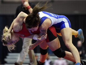 Emily Kessler of the Wessmen WC (in red) battles with Madison Parks of the London Western WC (in blue) during the Canadian Team Wrestling Trials at the Millennium Centre in Sherwood Park on Friday Dec. 4.