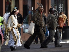 Members of Krampusnacht Edmonton walk on Whyte Avenue in Edmonton on Saturday, Dec. 5, 2015. In German-speaking Alpine folklore, Krampus is a horned, anthropomorphic figure who punishes children during the Christmas season who have misbehaved, in contrast with St. Nicholas, who rewards well-behaved ones with gifts.