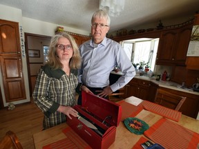 Petra and Rick Schulz pose on Feb. 3, 2015, with the cooking kit of their son Daniel (Danny) Schulz, 25, who died on April 30, 2014, from fentanyl poisoning.