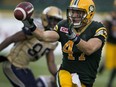 Edmonton Eskimos' JC Sherritt laterals the ball after making an interception against the Winnipeg Blue Bombers during second half CFL action on July 25, 2015 at Commonwealth Stadium.