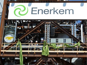 Alberta Environment Minister Robin Campbell, CEO Vincent Chormet and Mayor Don Iveson cut the ribbon during the grand opening ceremonies for the  Enerkem waste to biofuels and chemical facility at the Edmonton Waste Management Centre on June 4, 2014.