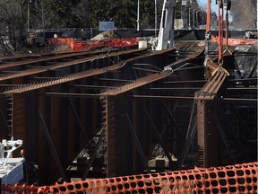 Several steel girders buckled during installation for the 102nd Avenue bridge replacement project over Groat Road on Monday, March 16, 2015.