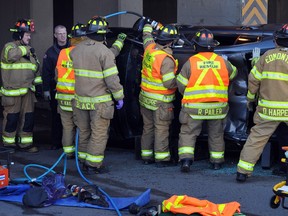 Edmonton firefighters use the Jaws of Life to cut the roof off of a Honda Accord to get the trapped driver out after a collision in 2012.