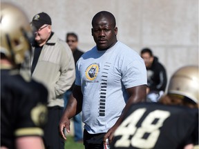 Defensive tackle Almondo Sewell, photographed in May 2015 helping out at the Edmonton Huskies spring training camp, was one of two key starters re-signed with the Edmonton Eskimos through the 2017 season. Slotback Adarius Bowman also committed to another two years.