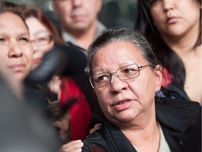 Peacha Atkinson speaks with media and is comforted by family members at the Edmonton Law Courts on April 11, 2012. Peacha died from complications of colon cancer on Dec. 18. 2015.