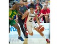 Canada's Kia Nurse dribbles past Brazil's Gilmara Justino during a semifinal game at the FIBA Americas Women's Championship basketball tournament at the Saville Community Sports Centre on Aug. 15, 2015.