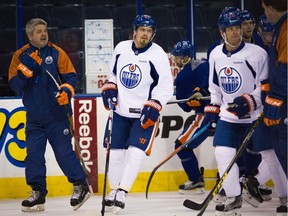 Edmonton Oiler coach Todd McLellan, left, instructs players from the ice during an Oilers practice at Rexall Place on Dec. 3, 2015. Topher Seguin/Edmonton Journal
