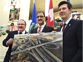 Edmonton Mayor Don Iveson (R), federal Minister of Infrastructure and Communities Amarjeet Sohi and provincial Transportation Minister Brian Mason (L) celebrate Monday the official completion of the $205-million Queen Elizabeth II Highway and 41st Avenue SW interchange at City Hall in Edmonton, December 21, 2015.