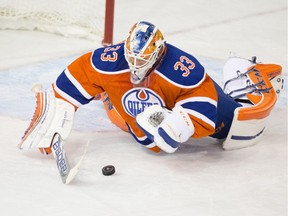 Edmonton Oilers' goalie Cam Talbot (33) jumps on the puck against the Winnipeg Jets during NHL action at Rexall Place in Edmonton on December 21, 2015.