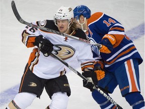 Anaheim's Carl Hagelin (26) and Edmonton's Jordan Eberle (14) collide as the Oilers and Ducks clash at Rexall Place in Edmonton, Dec. 31, 2015.