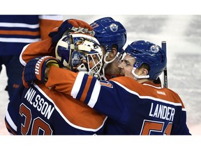 Edmonton Oilers goalie Anders Nilsson (39) gets congratulations from Anton Lander (51) and Oscar Klefbom (77) after Oilers scored in overtime defeating Dallas Stars 2-1 at Rexall Place in Edmonton, Dec. 4, 2015.