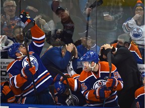 Edmonton Oilers' Taylor Hall catches a puck while everyone else on the bench ducks during an NHL game against the Buffalo Sabres at Rexall Place on Dec. 6, 2015.