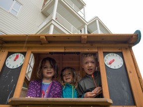Amelia Owens, left, Emily Fromhart and Bennett Smith play outside at the Primrose Place Family Centre daycare overlooked by balconies belonging to senior residents of the Ottewell Place Lodge on July 22, 2015.
