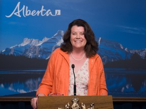 Jobs Minister Lori Sigurdson smiles during a June 29, 2015 news conference in Edmonton to announce that Alberta's minimum wage will be increased to $15 per hour by 2018.