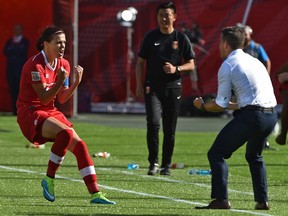 Christine Sinclair celebrates with head coach John Herdman her goal on a penalty kick in extra time  that gave Canada a 1-0 win over China during the FIFA Women's World Cup opener at Commonwealth Stadium in Edmonton, June 6, 2015.