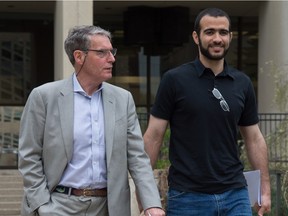 Omar Khadr walks out of the courthouse a free man with his lawyer Dennis Edney in Edmonton on May 7, 2015.