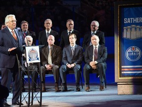 Glen Sather speaks surrounded by Oilers alumni during his banner-raising ceremony at Rexall Place in Edmonton on Dec. 11, 2015.