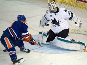 Forward Taylor Hall (4) scores the game winning goal on goaltender Martin Jones (31) as the Edmonton Oilers beat the San Jose Sharks at in overtime Rexall place in Edmonton, Dec. 9, 2015.