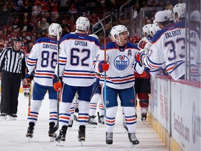Taylor Hall (4) of the Edmonton Oilers celebrates with teammates on the bench after scoring against the Arizona Coyotes during a Nov. 12, 2015, game in Arizona. Many of the current Oilers are too young to remember the Oilers' Stanley Cup wins.