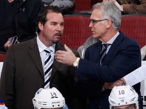 General manager Craig MacTavish (R) of the Edmonton Oilers talks with interim coach Todd Nelson on the bench during the first period of the NHL game against the Arizona Coyotes on Dec. 16, 2014 in Glendale, Ariz.