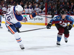 Teddy Purcellof the Edmonton Oilers takes a shot against Nick Holden of the Colorado Avalanche at Pepsi Center on December 19, 2015 in Denver, Colo.