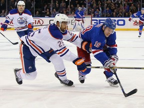Darnell Nurse of the Edmonton Oilers checks Jesper Fast of the New York Rangers during the second period at Madison Square Garden on Dec. 15, 2015 in New York City.