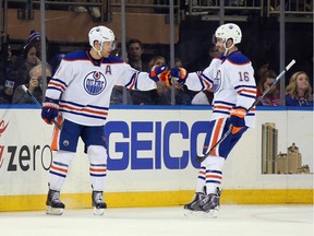 Taylor Hall, left, of the Edmonton Oilers celebrates his powerplay goal at 5:12 of the first period against the New York Rangers and is joined by Teddy Purcell at Madison Square Garden on Dec. 15, 2015 in New York City.