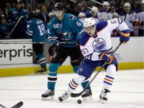 David Perron of the Edmonton Oilers, right, controls the puck in front of Melker Karlsson of the San Jose Sharks on Dec. 9, 2014 in San Jose, Calif.