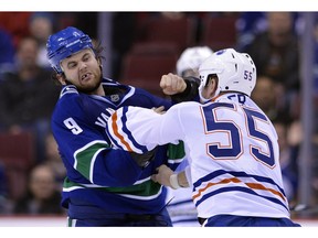 VANCOUVER, CANADA - JANUARY 20: Zack Kassian #9 of the Vancouver Canucks and Ben Eager #55 of the Edmonton Oilers fight during the third period of NHL action on January 20, 2013 at Rogers Arena in Vancouver, British Columbia, Canada.