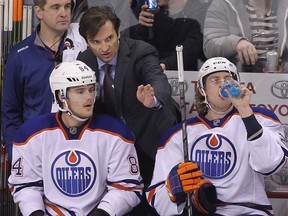 Head coach Dallas Eakins of the Edmonton Oilers talks to Oscar Klefbom during NHL action against the Winnipeg Jets at the MTS Centre on Dec. 3, 2014 in Winnipeg.