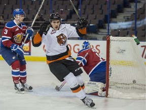 Goalie Patrick Dea of the Edmonton Oil Kings looks behind him as Matt Bradley of the Medicine Hat Tigers scores a power play goal at Rexall Place in Edmonton on Dec. 15.