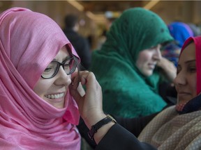 Suzanne French (left) and Lindsay Baranowski try on a hijab at the Students Union building at the University of Alberta on Monday, Dec. 7, 2015