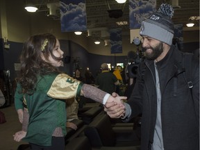 Eskimos quarterback Mike Reilly greets a young fan upon his return to Edmonton on Monday, Nov. 30, 2015.