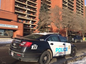An Edmonton Police cruiser sits outside an apartment building at Jasper Avenue and 88th Street on Saturday, Dec. 5, 2015. Police have confirmed two men are dead while another is in hospital after apparent overdoses.