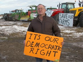 New Sarepta area farmer Bruce Wrubleski holds a sign at an anti-Bill 6 rally outside a consultation meeting on Bill 6 in Leduc on Dec. 7.