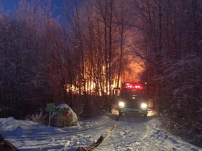 Firefighters battle the blaze at the Ardrons' house north of Stony Plain on Monday, Dec. 15, 2015. The family of nine is now homeless.