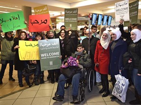 Syrian refugees are welcomed by Islamic agencies and a team of youth from different schools across Edmonton as they arrive at Edmonton International Airport on Dec. 21. The pace of refugees' arrival in Edmonton is picking up.