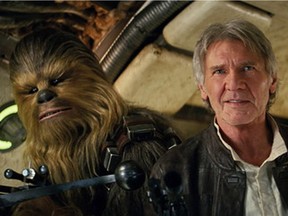 This photo provided by Lucasfilm shows Peter Mayhew as Chewbacca and Harrison Ford as Han Solo in Star Wars: The Force Awakens.