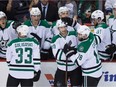 Dallas Stars' Jason Spezza, centre, and Patrick Eaves, front right, celebrate Spezza's empty-net goal against the Vancouver Canucks during the third period of an NHL hockey game in Vancouver, B.C., Dec. 3, 2015.
