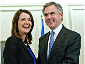 Then-premier Jim Prentice and former Wildrose leader Danielle Smith speak to the media after a caucus meeting in Edmonton on Dec. 17, 2014. Prentice's caucus met to discuss a bid by at least half the official Opposition to cross the floor.