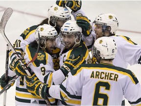 Alberta Golden Bears captain Kruise Reddick, centre, is congratulated after scoring against UQTR Patriotes during a semi-final playoff game in Halifax on March 14, 2015.