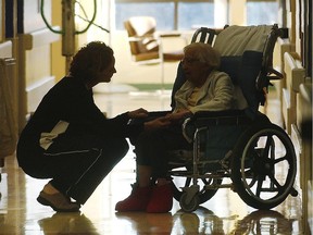 A nurse chats with  an elderly  resident of a continuing care centre.