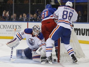 New York Rangers' left wing Rick Nash  slips behind Edmonton Oilers goalie Anders Nilsson after scoring a goal during the second period, Tuesday, Dec. 15, 2015, in New York.