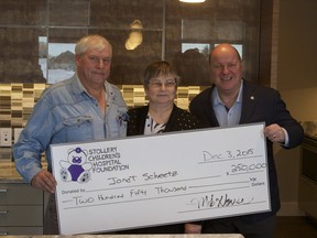Leonard and Janet Scheetz of Leduc County accept the Mighty Millions Lottery grand prize cheque from Mike House, president and CEO of the Stollery Children's Hospital Foundation.