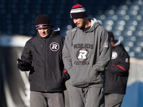 Ottawa Redblacks' head coach Rick Campbell, left, and walks with the team's offensive coordinator and quarterbacks coach Jason Maas during a Grey Cup football practice in Winnipeg on Nov. 28, 2015.