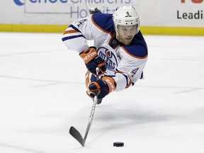 Former Edmonton Oilers' Taylor Hall dives for the puck during the third period of an NHL hockey game against the Anaheim Ducks, Wednesday, Dec. 10, 2014, in Anaheim, Calif. The Ducks won 2-1.