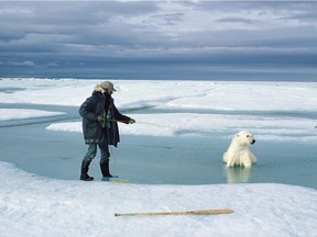 Scientist Ian Stirling lassos a tranquilized bear to keep its head above water.