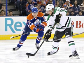 Dallas Stars' Tyler Seguin (91) is chased by Edmonton Oilers' Mark Fayne (5) during first period NHL action in Edmonton, Alta., on Friday December 4, 2015.