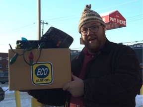 Dave Claus, the Spirit of Holiday Waste, shows how to properly dispose of old electronics at the Mountain Equipment Co-op recycling depot Thursday.