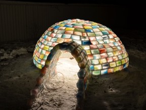 A light shines inside the finished igloo.